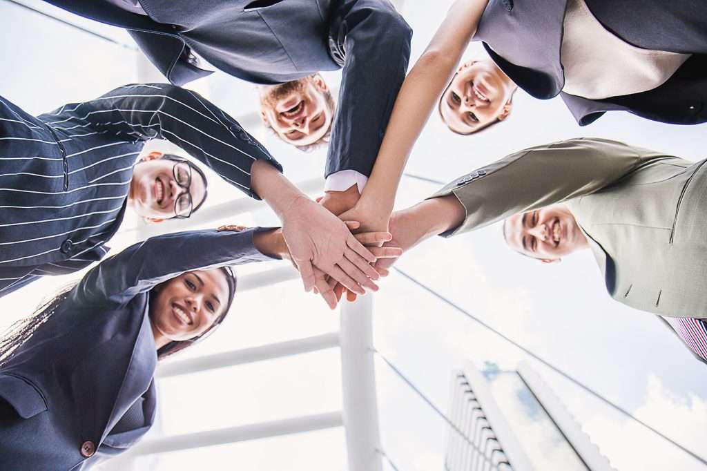 Multicultural business professionals collaborating in a corporate environment, representing enterprise payroll and HR transformation services.